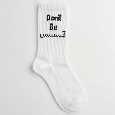 White ribbed crew sock with a Don't Be slogan in black English and Arabic lettering