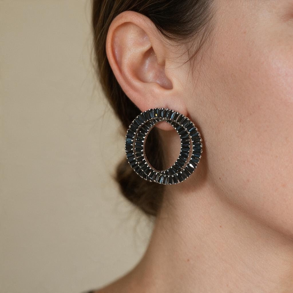 Woman with a low bun wearing a black baguette crystal double circle earring