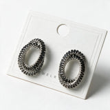 Pair of black double oval baguette crystal earrings on a white display card