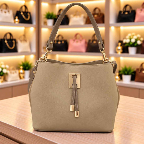Beige suede look bucket bag with a darker taupe handle, gold clasp and stitched front tabs