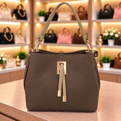 Grey brown bucket bag with contrast taupe handle and front tabs and a gold rectangle clasp