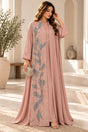 Woman in a dusty pink two piece abaya with blue floral embroidery down the front