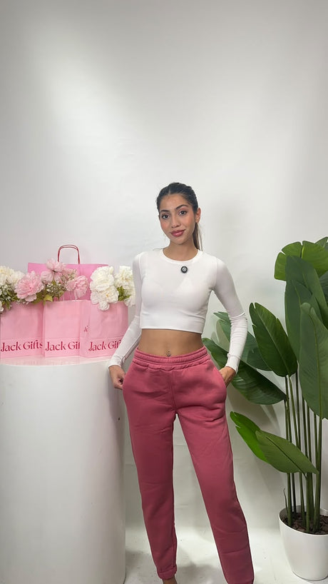 Front view of rose pink cuffed sweatpants showing the relaxed fit through the hip and thigh