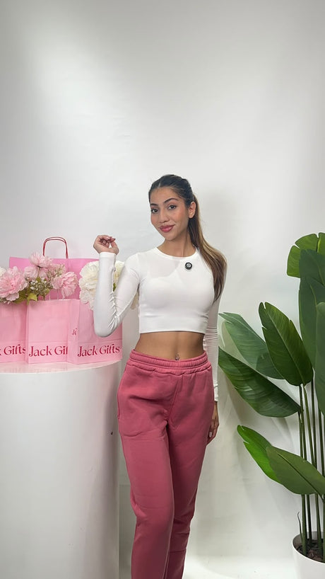 Women's dusty rose sweatpants with a wide elastic waistband, styled with a white fitted crop top