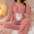 Dusty rose fluffy PJ set with a button V neck and a sleepy cat holding a pink heart, worn on a bed