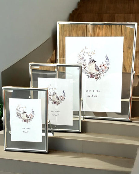 Three silver edged frames at 10x15, 13x18 and 20x25 arranged along staircase steps