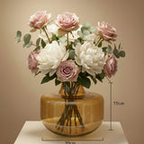 Squat amber glass barrel vase on a white plinth, marked 20cm wide and 15cm tall