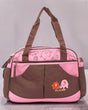 Pink and brown baby changing bag with elephant embroidery, safari animal print panel and two carry handles