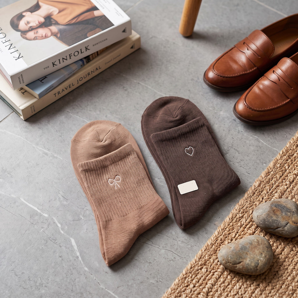 Tan and dark brown ribbed socks laid flat with bow and heart embroidery