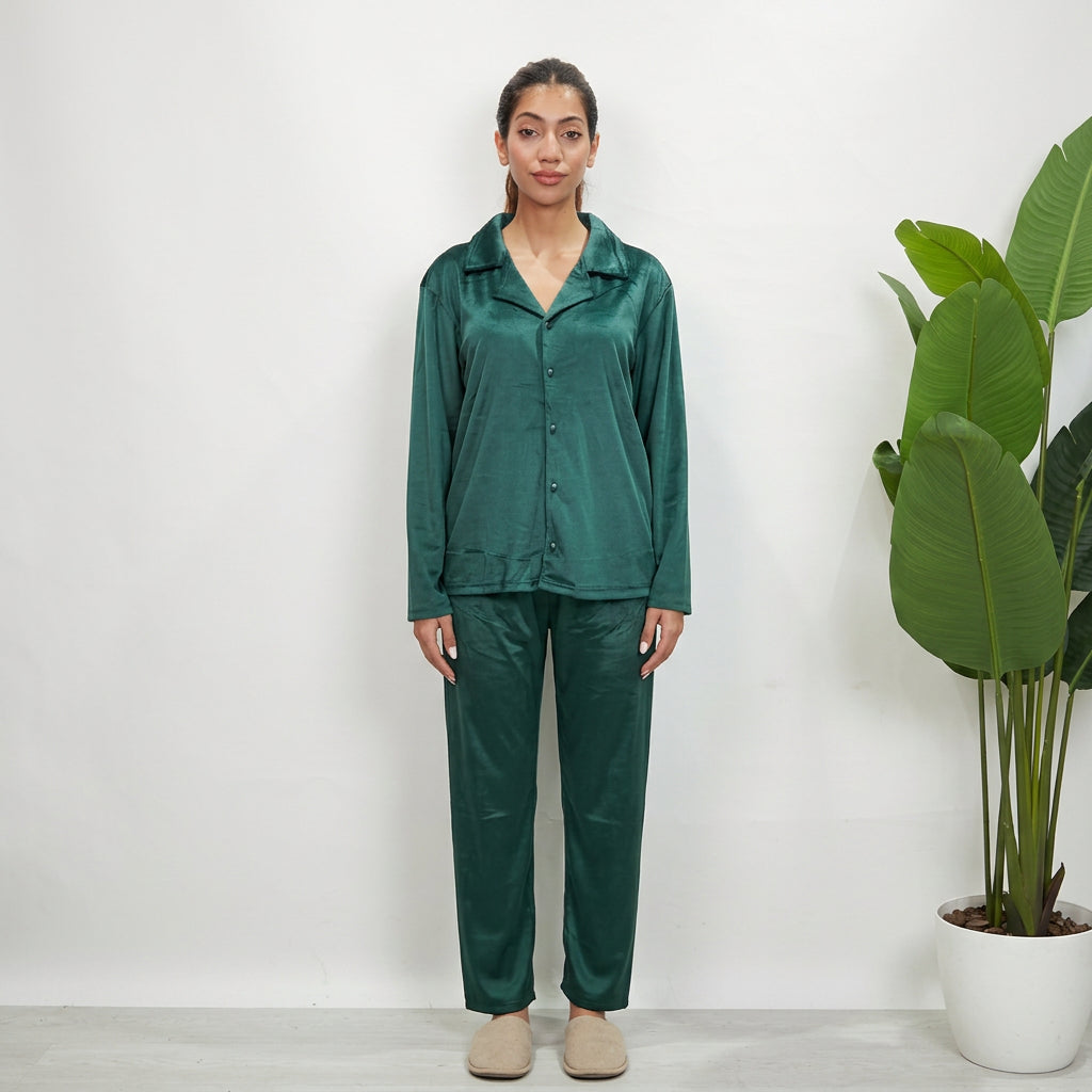 Full length emerald green velvet pajama set worn with cream slippers