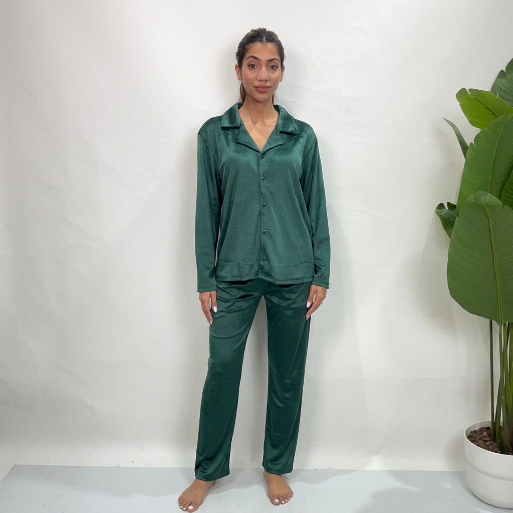 Woman in an emerald green velvet button up PJ set with collared shirt and straight pants