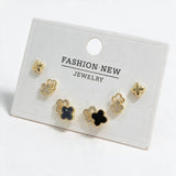Gold tone clover stud set with polished crosses, pave flower outlines and black enamel clovers