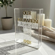 The English prayer raised in white on a clear block, its shadow cast across marble
