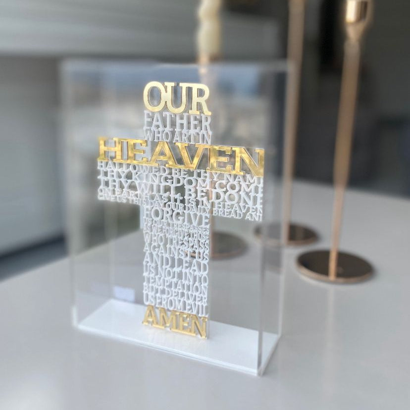 Our Father in raised white letters shaping a cross, Our and Heaven and Amen in gold