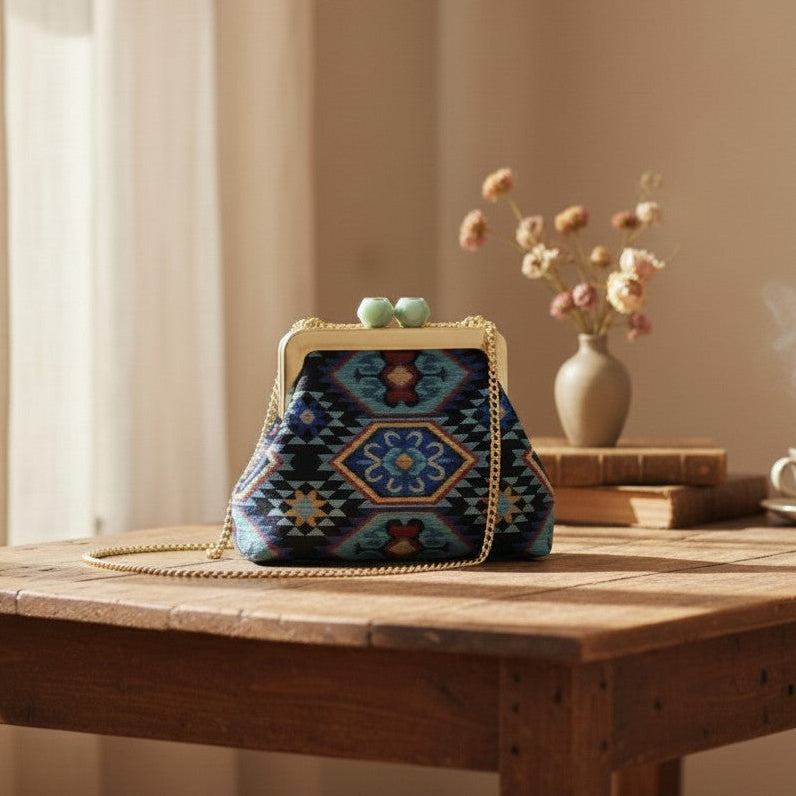 Navy ethnic medallion embroidery on a handmade frame bag with mint green clasp