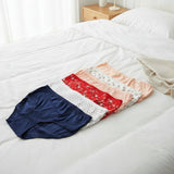 Everyday cotton briefs in a colour run from navy to peach on a white bed