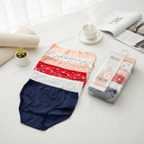 Women's navy, red floral, peach and dotted briefs laid out beside their pack