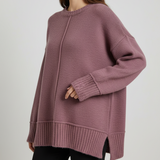 Pink oversized knit top with side slits and a long ribbed hem