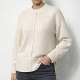 Cream toned white knit top close up, centre front seam running down to a deep rib hem