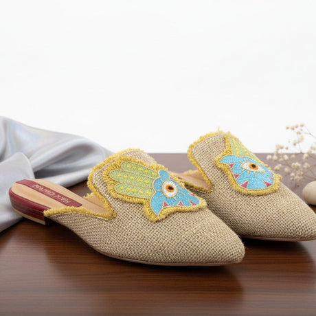 Pair of decorative handmade eye slippers on a wooden surface