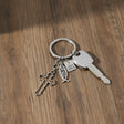 Faith key ring with cross, fish and Holy Bible charm on a wooden surface