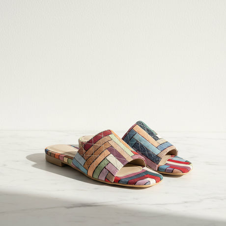 Colorful fashionable handmade slippers on a neutral backgrond