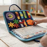 Navy felt busy board with buckles, a clock, gears and laces as a child reaches for the pieces
