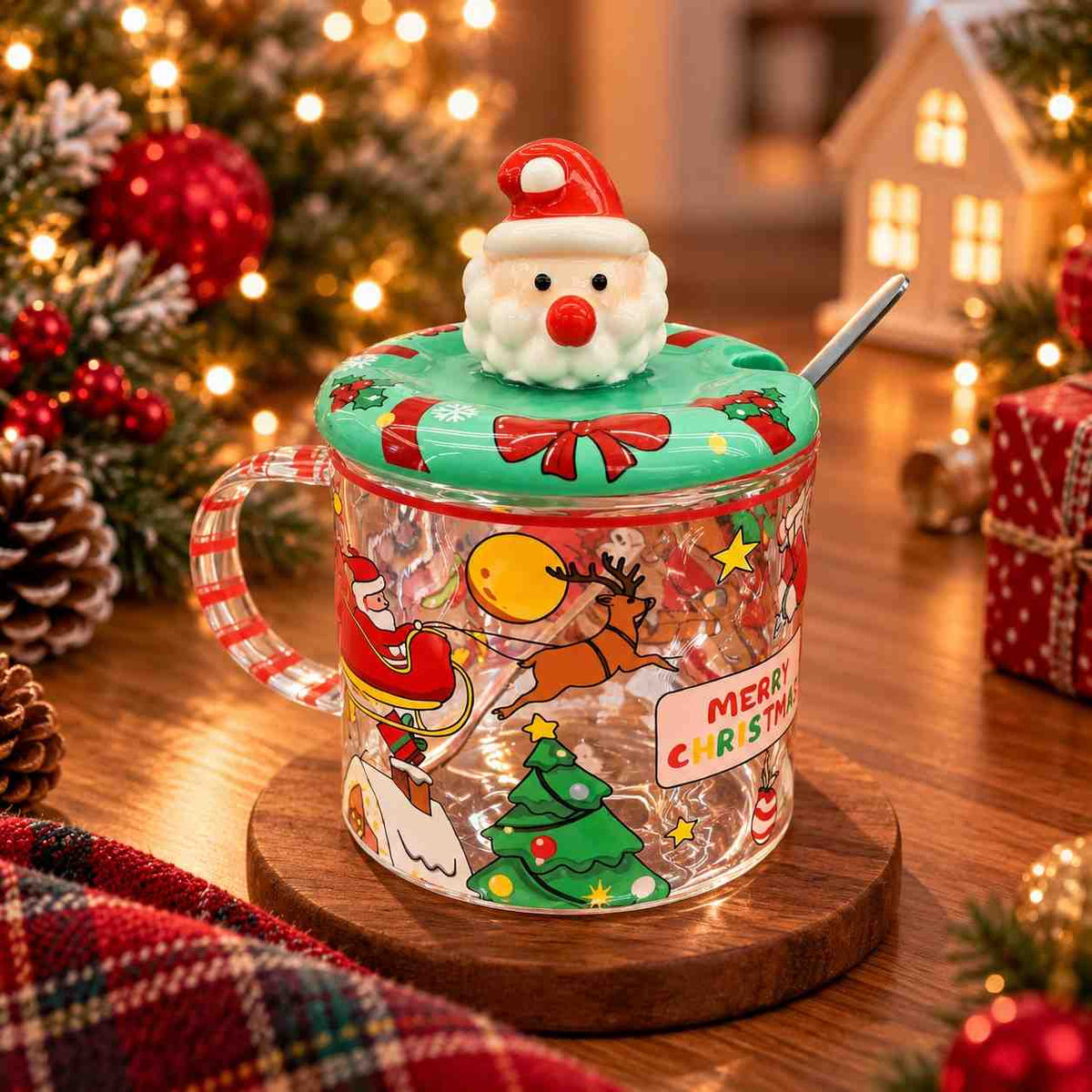 Clear glass mug with a Santa sleigh print, striped handle and a green Santa head lid