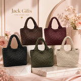 Five woven handbags in black, brown, green, and beige on a decorative stand with 'Jack Gifts' branding.