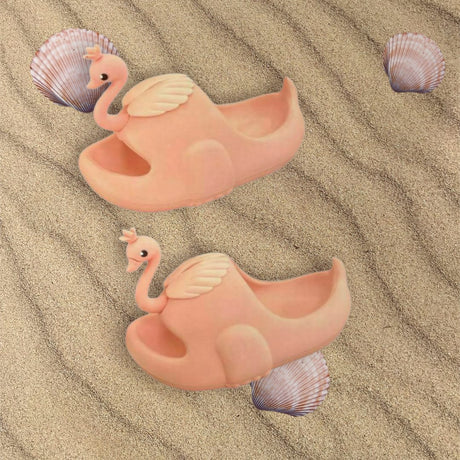 Peach flamingo slides with soft cushioned sole shown on rippled sand