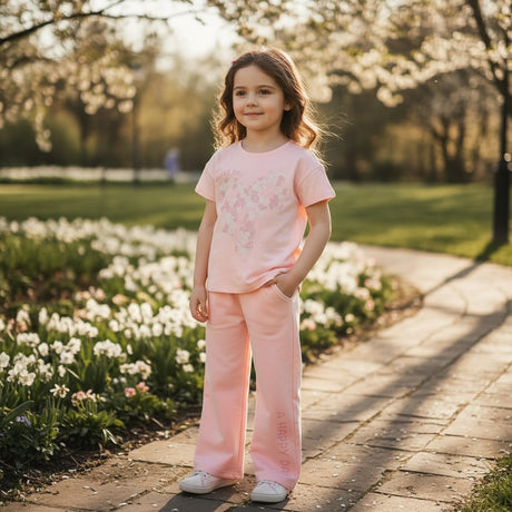 Girl in a pink floral heart print tee and matching wide leg pants
