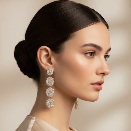 Pair of diamond-studded floral earrings worn by a woman on a beige background