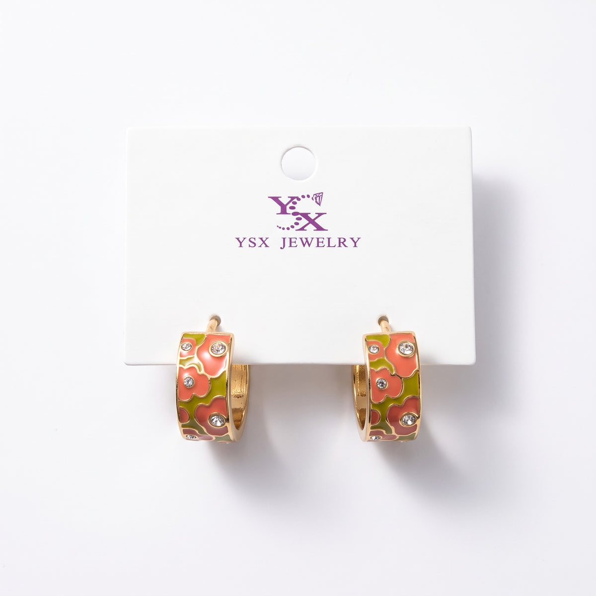 Coral and olive floral enamel hoop earrings with small clear crystals on a card