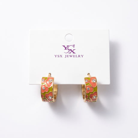 Coral and olive floral enamel hoop earrings with small clear crystals on a card