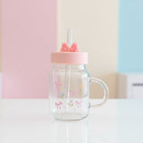 Clear glass mug with a pink bow and tulip print, pink lid and a moulded bow topper