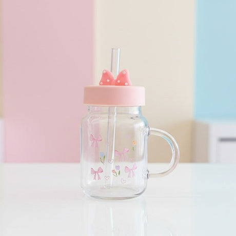 Clear glass mug with a pink bow and tulip print, pink lid and a moulded bow topper