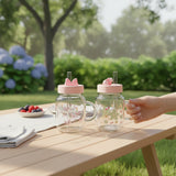 Two floral glass mugs on a picnic table with hydrangeas and a bowl of berries