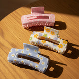 Floral claw clips in pink, white, and cornflower blue, daisy print