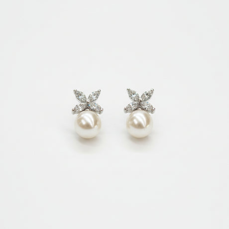 A pair of floral pearl drop earrings on a white background