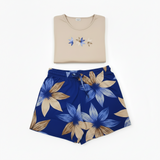Beige shirt with floral design and blue floral skirt on a white background