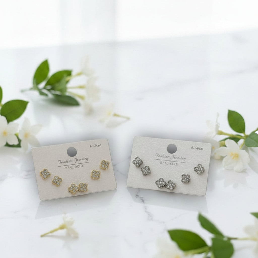 Pair of floral earrings on display cards with a white background and green leaves