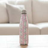 Cream vacuum flask with vertical pink rose stripes on a white wood table