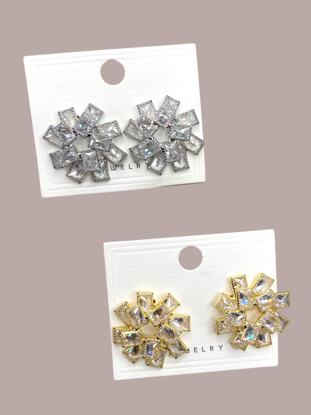 Two pairs of silver and gold flower-shaped earrings on display cards against a beige background