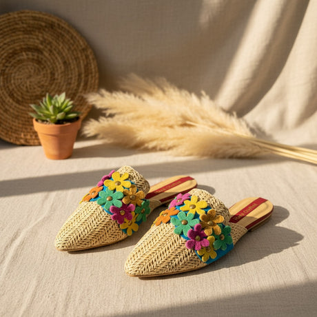Woven handmade sandals with colorful flower decorations on a neutral background