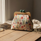 Wildflower print handbag on a rustic wooden table with dried lavender