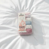 Pastel floral briefs boxed in a clear pack, lying on white bedding