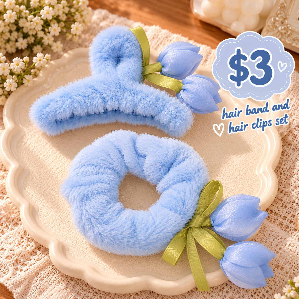 Blue fluffy claw clip and scrunchie with satin tulip buds and green ribbon on a cream dish
