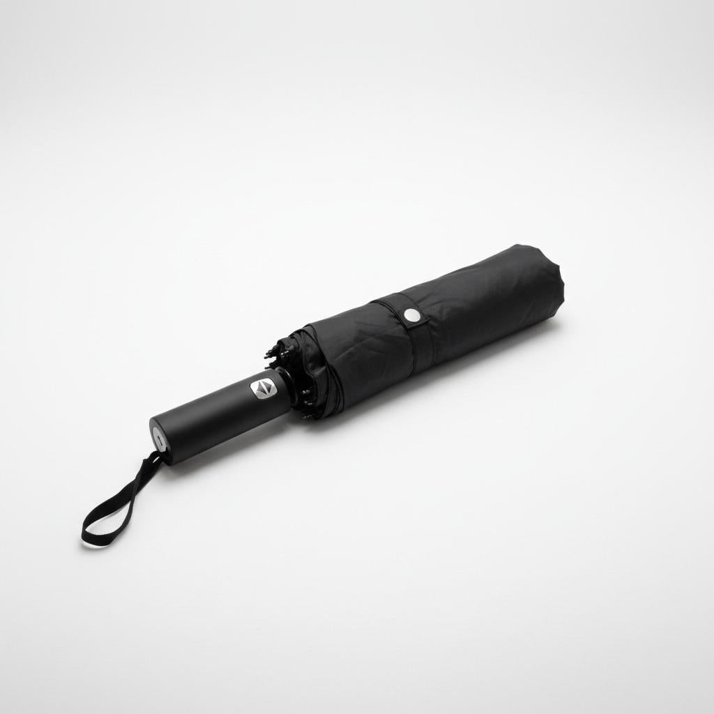 Folded black everyday shield umbrella on a white background