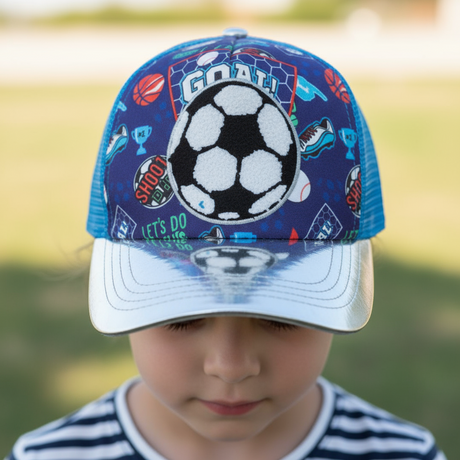 Boy wearing a navy football kids cap with a fluffy chenille soccer ball patch and white brim