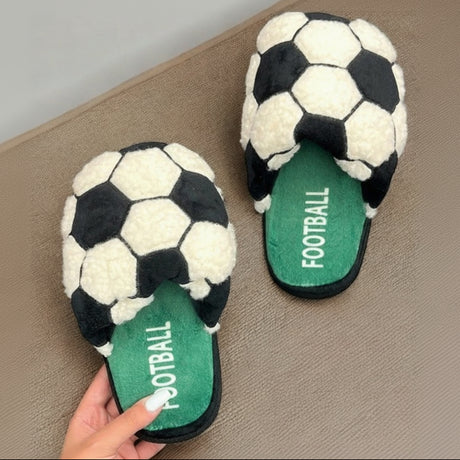 Pair of slippers with soccer ball design and 'FOOTBALL' text on a beige surface